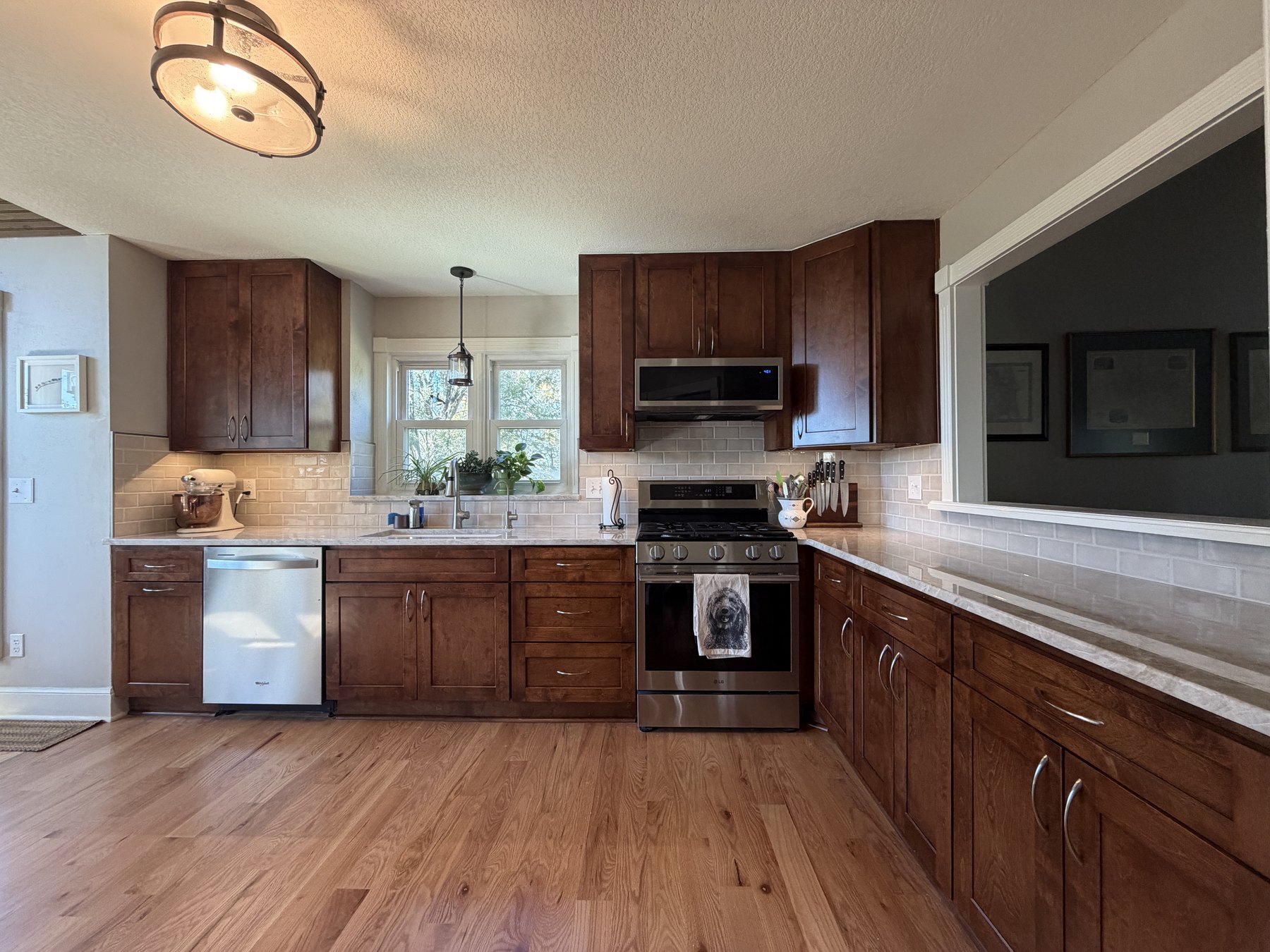 Full kitchen remodel in Liberty, MO with stained maple shaker cabinets and Taj Mahal quartzite countertops